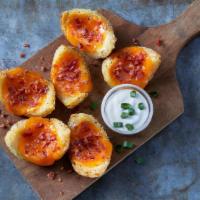 Classic Potato Skins · 6 Potato skins loaded with melted cheese, crispy bacon, Ranch sour cream and green onions.