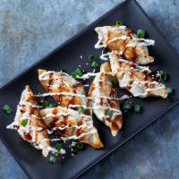 Korean Wasabi Pot Stickers · Steamed pork dumplings drizzled with Korean BBQ sauce and Cucumber-Wasabi Ranch. Topped with...