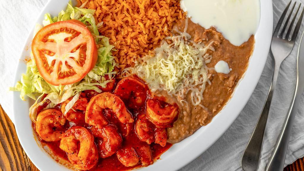 Camarones A La Diabla · Shrimp in a hot spicy sauce, with rice, beans, sour cream, guacamole, lettuce, tomatoes, tortillas and cheese.