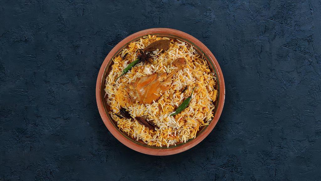 Hyderabadi Chicken Biryani · Long grain basmati rice cooked with tender chicken and aromatic Indian herbs.