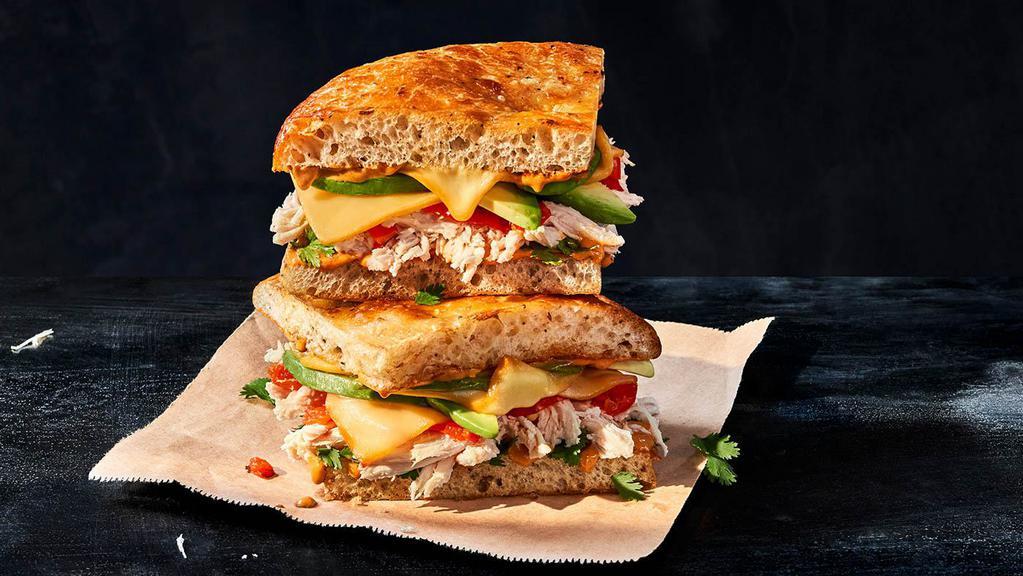 Chipotle Chicken Avocado Melt · Whole (940 Cal.), Half (470 Cal.) Smoked, pulled chicken raised without antibiotics, smoked Gouda, fresh avocado and cilantro, zesty sweet Peppadew™ peppers and chipotle sauce on Black Pepper Focaccia. Allergens: Contains Wheat, Milk, Egg