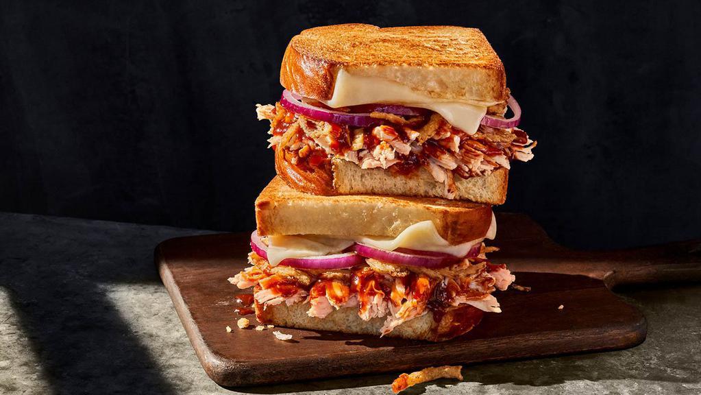 Smokehouse Bbq Chicken Sandwich · Whole (760 Cal.), Half (380 Cal.) Smoked, pulled chicken raised without antibiotics, BBQ sauce, red onions, aged white cheddar, and frizzled onions on Classic White Miche. Allergens: Contains Wheat, Milk
