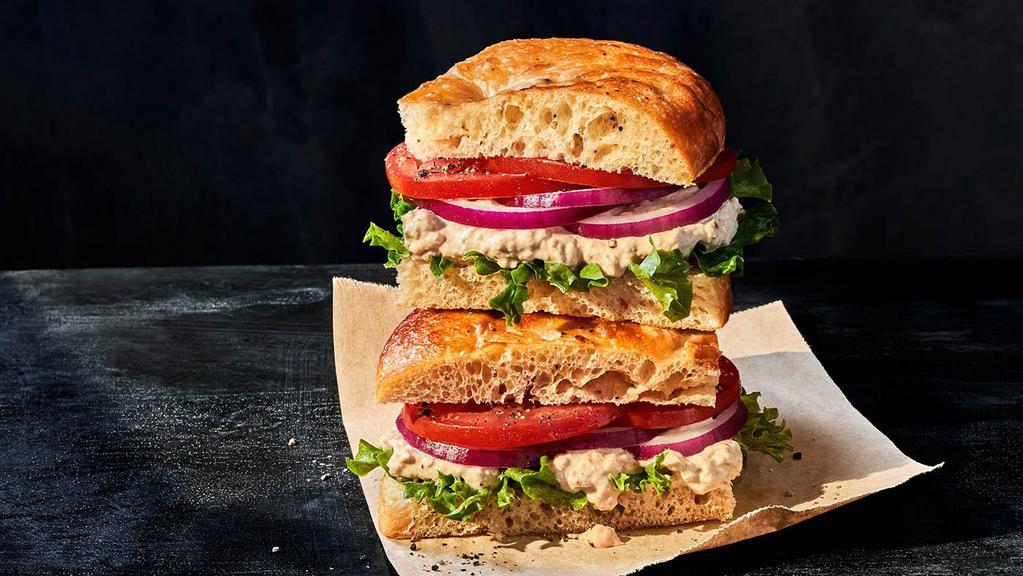 Tuna Salad Sandwich · Whole (740 Cal.), Half (370 Cal.) Special recipe tuna salad, emerald greens, vine-ripened tomatoes, red onions, salt and pepper on Black Pepper Foccacia. Allergens: Contains Wheat, Egg, Fish