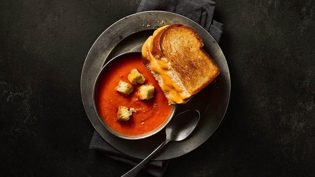 Classic Grilled Cheese & Creamy Tomato Soup · A half portion of our Classic Grilled Cheese served alongside a cup of Creamy Tomato Soup.