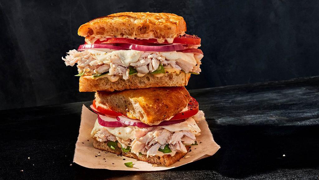 Toasted Frontega Chicken · Whole (830 Cal.), Half (420 Cal.) Smoked, pulled chicken raised without antibiotics, fresh mozzarella, salt and pepper, vine-ripened tomatoes, red onions, fresh basil and chipotle sauce on Black Pepper Focaccia. Allergens: Contains Wheat, Milk, Egg