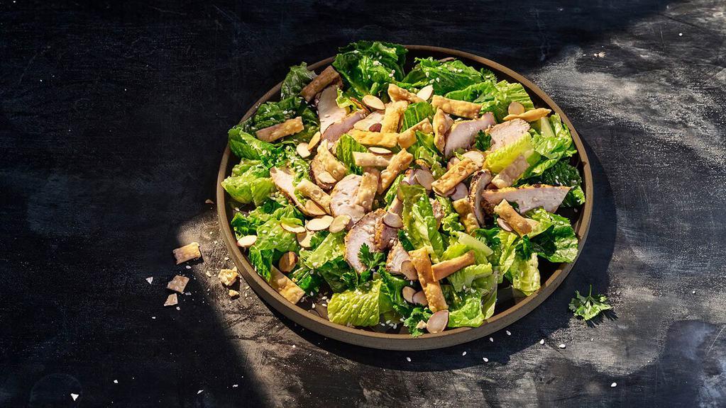 Asian Sesame Salad With Chicken · Whole (410 Cal.), Half (200 Cal.) Chicken raised without antibiotics, romaine, fresh cilantro, toasted almonds, sesame seeds and wonton strips tossed in Asian sesame vinaigrette. Allergens: Contains Wheat, Tree Nuts. May contain Egg