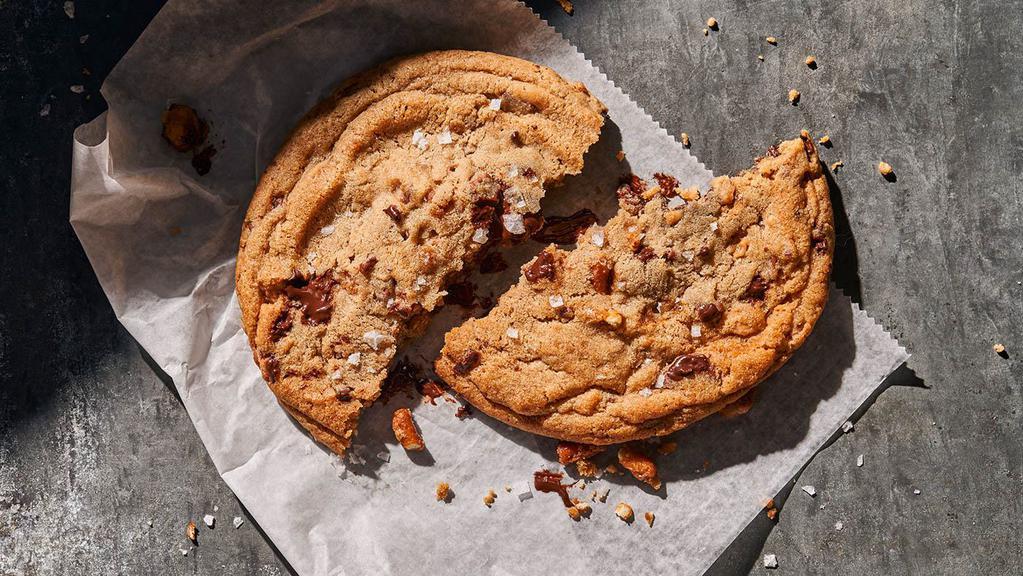 Kitchen Sink Cookie · 820 Cal. A salty, chocolaty, caramel confection big enough to share.  A large cookie with semi-sweet chocolate, milk chocolate, caramel pieces, pretzels and then topped with flake salt. Allergens: Contains Wheat, Soy, Milk, Egg