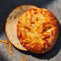 Asiago Bagel · 320 Cal. Freshly baked bagel made with chunks of asiago cheese baked inside and topped with ...
