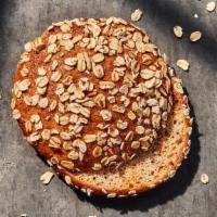 Sprouted Grain Bagel Flat · 180 Cal. Freshly baked sprouted whole grain bagel topped with oats, pinched and slightly fla...