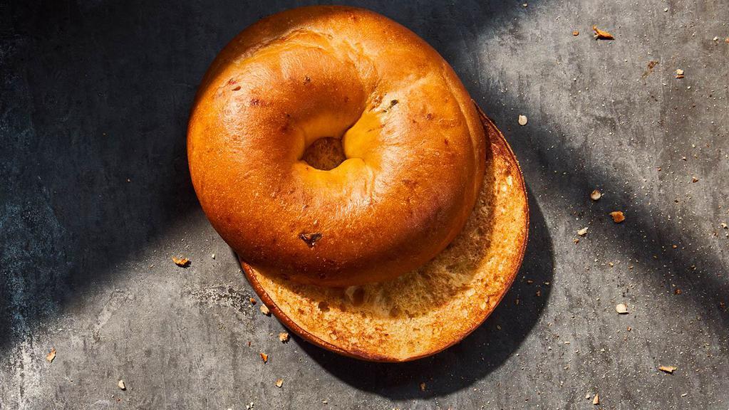 Jalapeno & Cheddar Bagel · 300 Cal. Freshly baked bagel made with chopped jalapenos, sharp cheddar cheese and a blend of salsa spices mixed in roasted corn flour dough Allergens: Contains Wheat, Milk