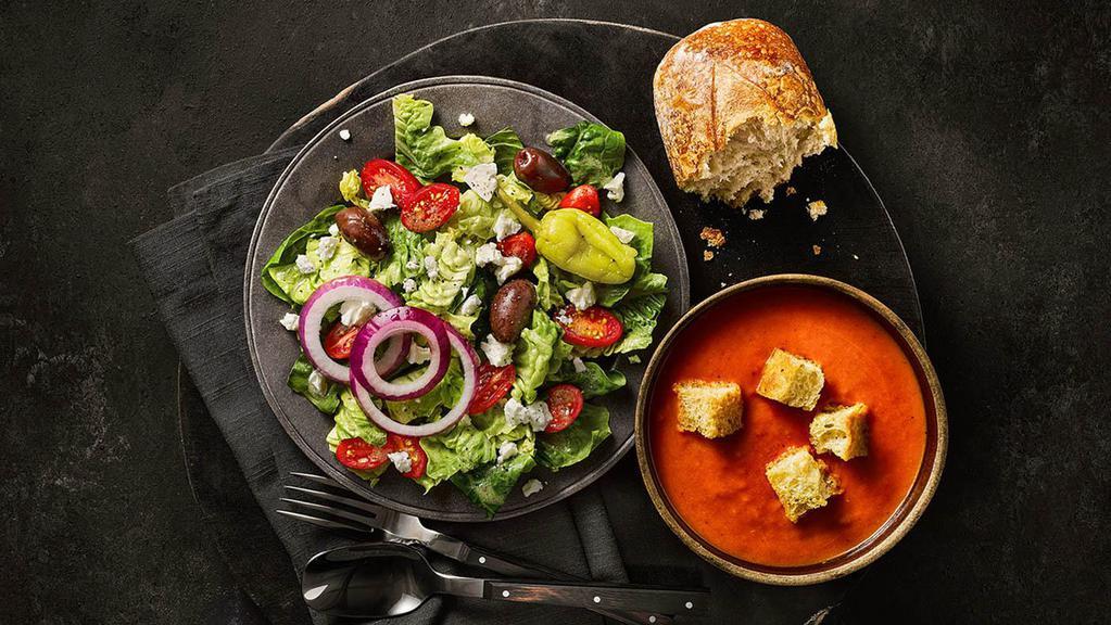 Greek Salad & Creamy Tomato Soup · A half portion of our Greek Salad served alongside a cup of Creamy Tomato Soup.
