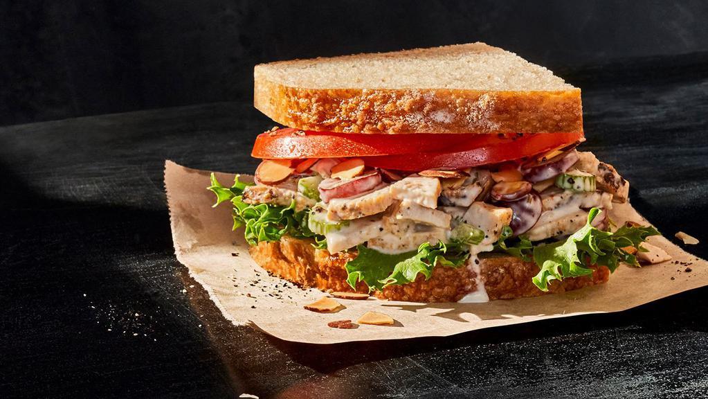Kids Napa Almond Chicken Sandwich · 310 Cal. Chicken raised without antibiotics tossed with diced celery, seedless grapes, toasted almonds and special dressing, and served with emerald green lettuce, vine-ripened tomatoes, salt, and pepper on Country Rustic Sourdough. Allergens: Contains Wheat, Egg, Tree Nuts