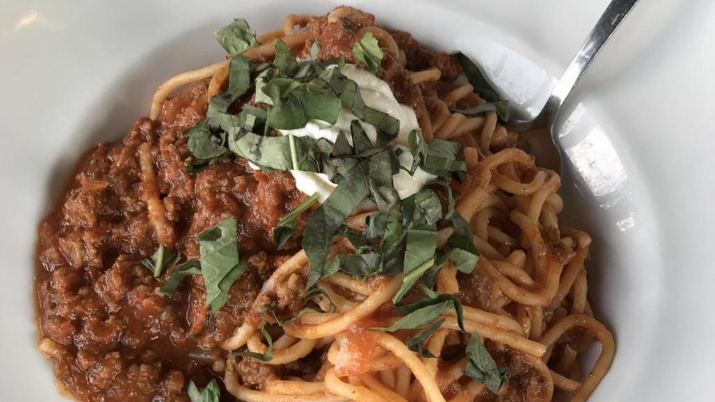 Spaghetti Bolognese · Slow cooked ground certified angus beef® in a housemade tomato marinara with garlic ricotta & basil.
