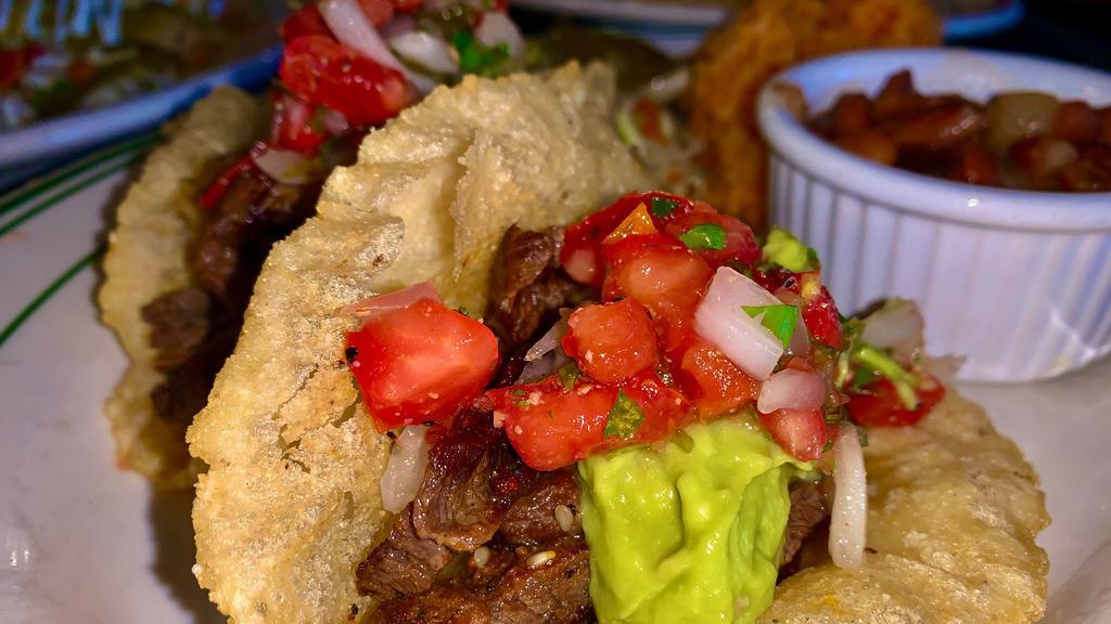 Skirt Steak  - 2 tacos, rice & beans · Topped with pico de gallo and guacamole.