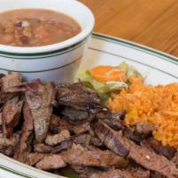 Skirt Steak · Served with Mexican rice, frijoles charros, guacmole, sour cream, pico de gallo, and tortillas