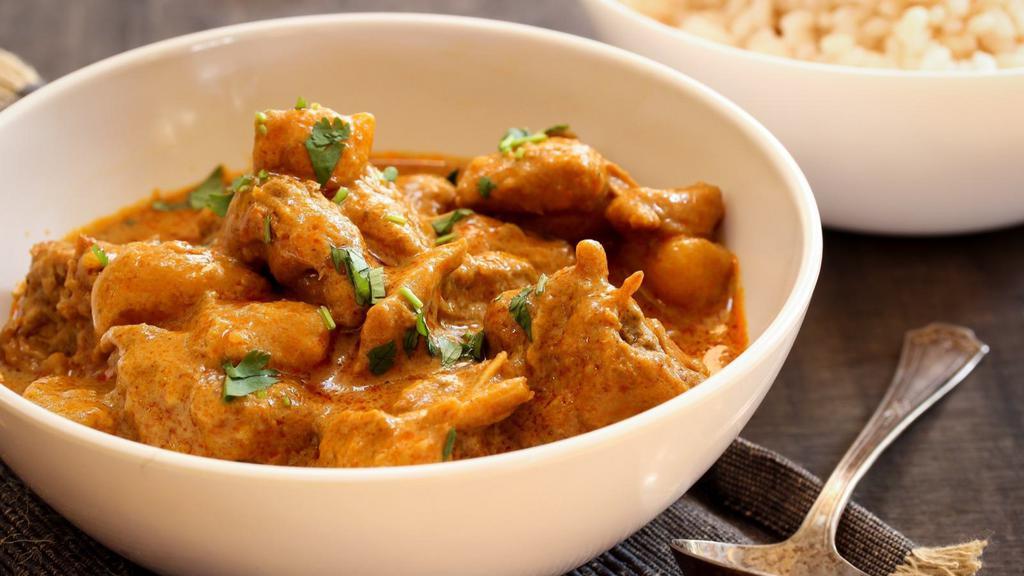 Chicken Curry · Hearty chicken cooked in a savory onion and tomato curry flavored with traditional Indian spices.