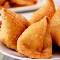 Lamb Samosas · Crispy turnovers filled with lamb and served with chutneys.