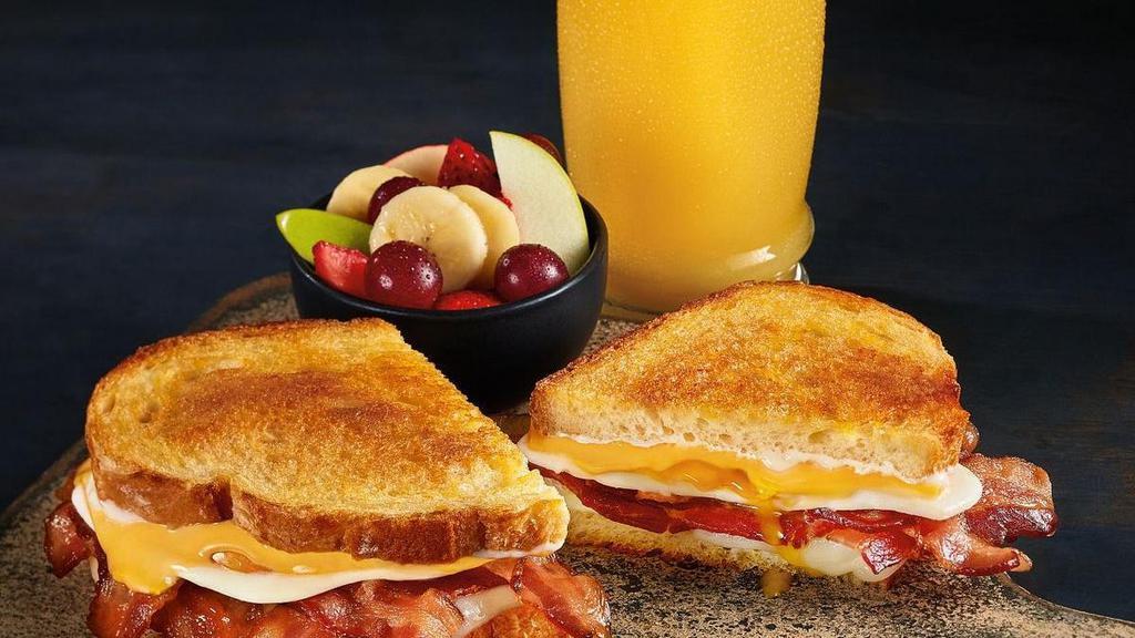 Breakfast N' Bread Melt - Combo · Bacon, eggs, American and Swiss cheeses and mayo on grilled artisan bread. All the breakfast essentials together in one melt. Includes your choice of a drink and a side to round out the meal.