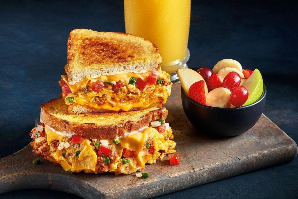 Rise 'N Spice Melt -Combo · Chorizo, Cheddar cheese, tortilla chips all scrambled with eggs and topped with American cheese, Pico de Gallo and Mayo. All of this goodness on grilled artisan bread. Includes your choice of a drink and a side to round out the meal.