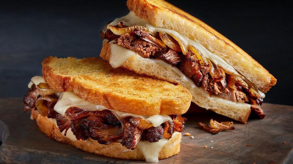 Hot Mess Melt · Go big or go home with tender slow-roasted beef, caramelized onions and sharp white Cheddar on grilled artisan bread.
