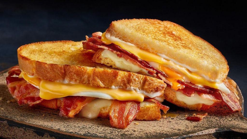 Breakfast N' Bread Melt · Bacon, eggs*, American and Swiss cheeses and mayo on grilled artisan bread. All the breakfast essentials together in one melt.