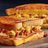 Hittin' Snooze Melt · Sausage, bacon, ham, scrambled eggs and American cheese on potato bread with a maple spiced ...