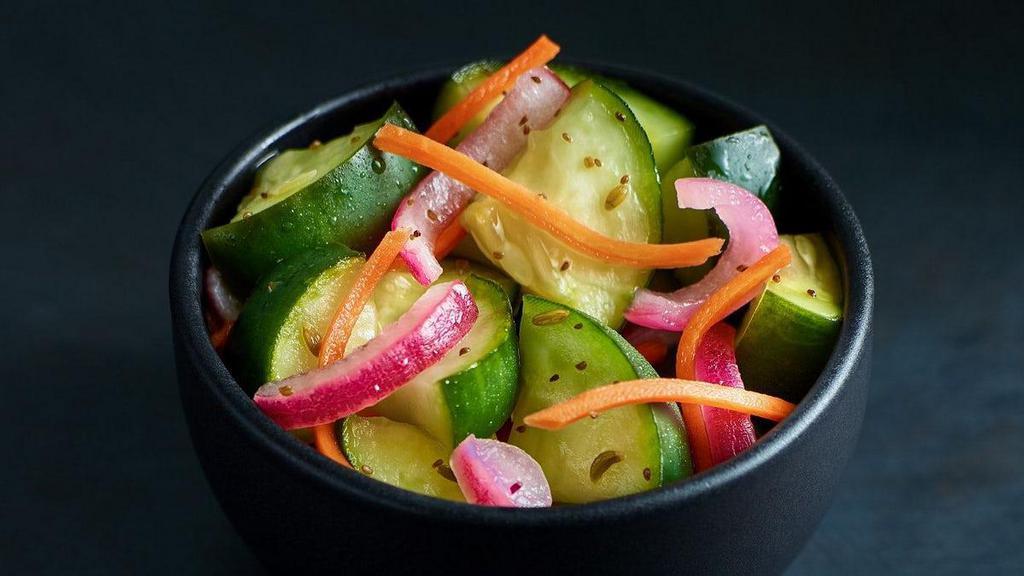 Pickled Cucumber Salad · A house-made tangy side of pickled cucumbers plus carrots and onions.