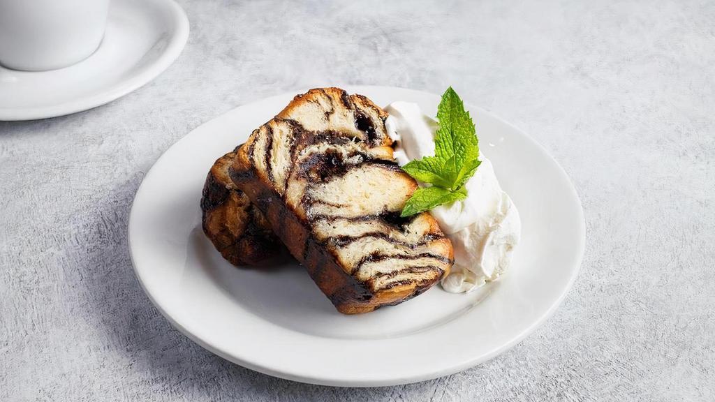Chocolate Babka · (Two slices). Layers of chocolate and buttery brioche served warm then topped with whipped cream.
