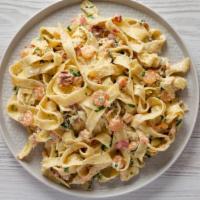 Chicken Fettuccine · Fettuccine and tender grilled chicken tossed with our creamy Alfredo sauce made with parmesa...