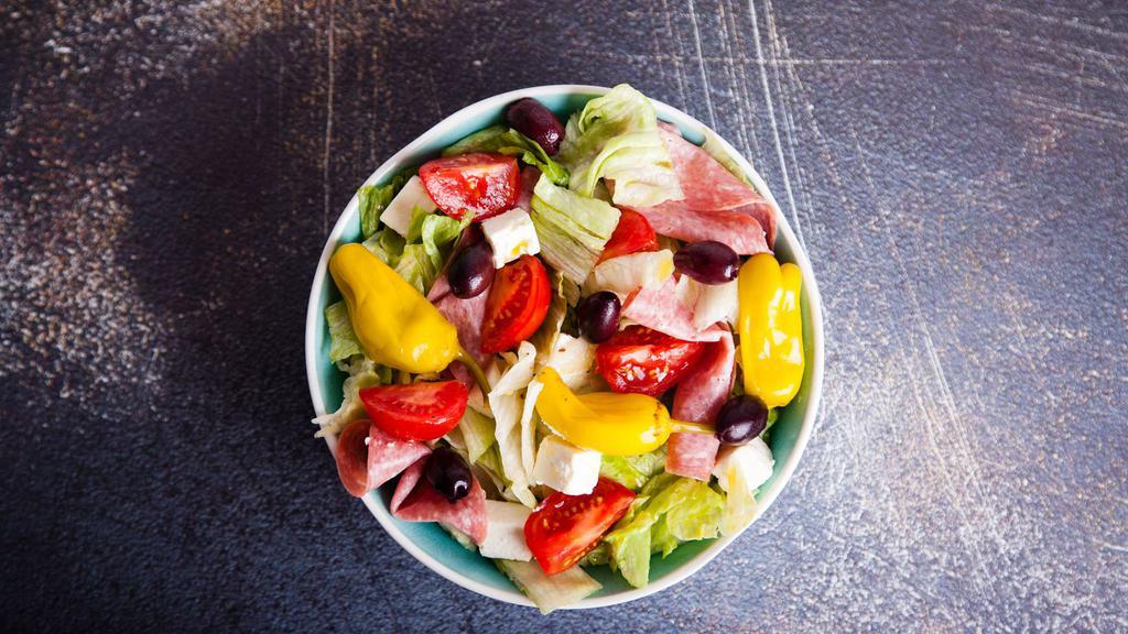 Chef Salad · Hearty combination of ham, salami, pepperoni, and Canadian bacon with spicy pepperoncini and mozzarella on a bed of fresh lettuce, tomatoes, onions, bell peppers and cucumber. Your choice of dressing.