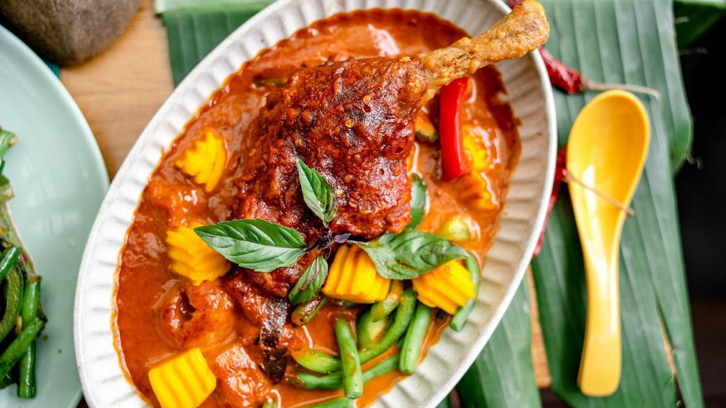 Pineapple Duck Curry · Spicy. Gluten-free. Mussamun coconut curry with crispy duck, bell peppers, pineapple, green beans, lychee, basil. Served with jasmine rice.