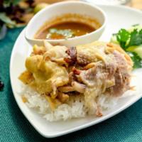 Khao Mun Gai · Poached chicken with a side of ginger-garlic rice, served with cucumber and ginger, garlic a...
