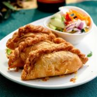 Curry Puff · Potato curry in a crispy potsticker wrapper served with cucumber salad