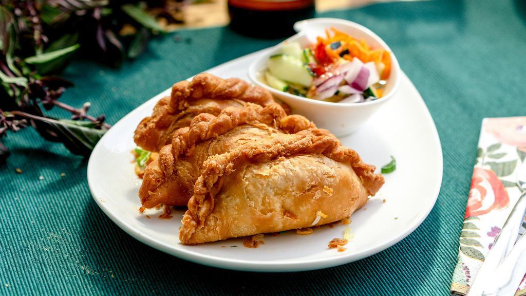 Curry Puff · Potato curry in a crispy potsticker wrapper served with cucumber salad