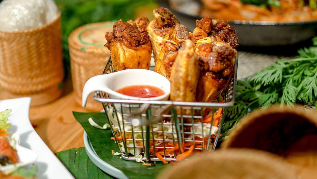 Chicken Wings · Deep-fried Thai-style marinated chicken wings served with sweet and sour sauce