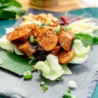 Sai Oua · Spicy. Spicy Northern-style pork sausage with Thai herbs served with ginger, fried peanuts, ...