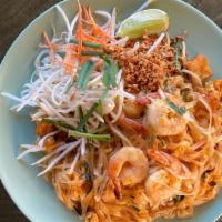 Pad Thai · Wok-fried thin rice noodles with tofu, eggs, bean sprouts, chives and crushed peanuts in tam...