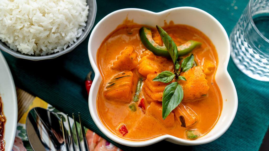 Red Curry   · Spicy. Vegan. gluten-free. Spicy red coconut curry with pumpkin, green beans, eggplant, bamboo shoots, bell peppers and basil. Served with jasmine rice. (V)(GF)