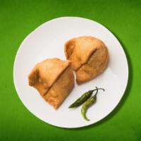 Samosa Supreme (Vegan) (2 pcs) · A delectable duo of handmade crisp cones filled with potatoes, peas, cumin, spiced and seaso...