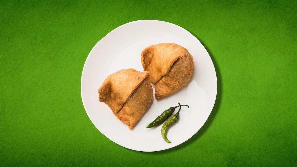 Samosa Supreme (Vegan) (2 pcs) · A delectable duo of handmade crisp cones filled with potatoes, peas, cumin, spiced and seasoned
