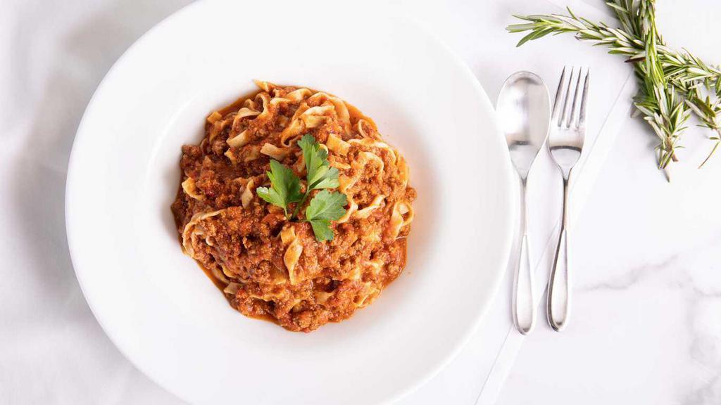 Fettuccine al Sugo · Housemade egg noodles with meat sauce.