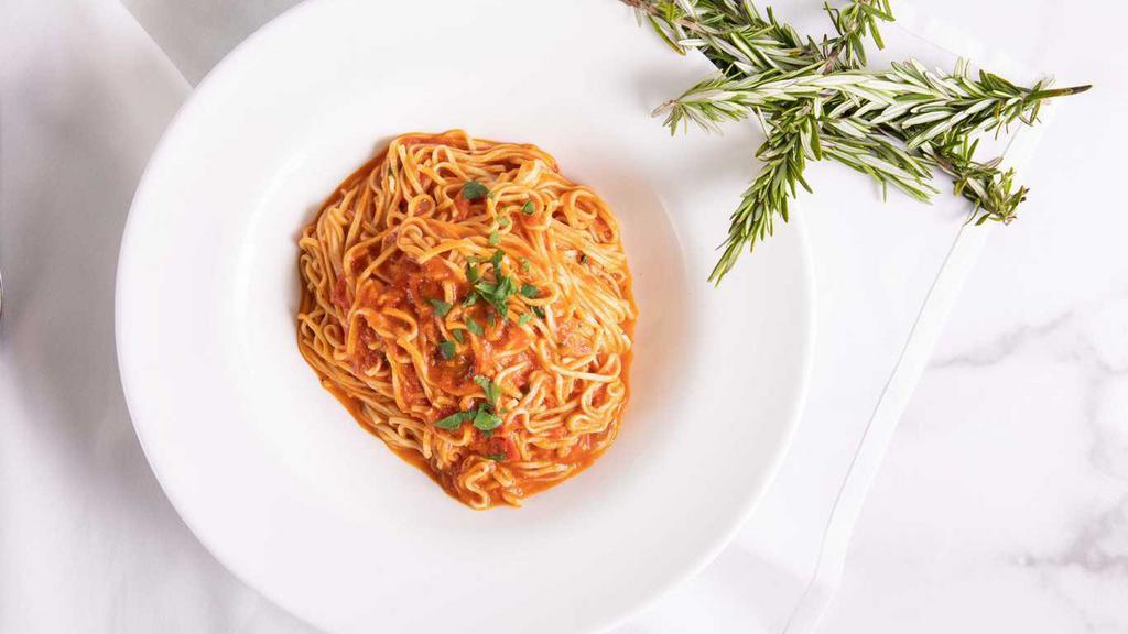 Taglierini, Aglio, Olio e Pomodoro · Housemade thin noodles, tomato, garlic, and olive oil sauce.