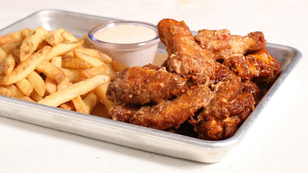 Chicken Wings · 10 chicken wings seasoned and perfectly fried, tossed in your choice of sauce and served with perfectly seasoned crispy fries.