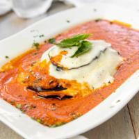 EGGPLANT PARMIGIANA · Sliced, breaded, and fried eggplant topped with mozzarella cheese and served in fresh tomato...