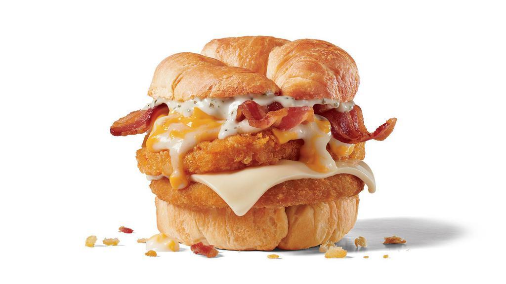 Chick-N-Tater Melt · Crispy chicken, bacon, hashbrown, Swiss cheese, white sauce, shredded cheddar cheese on a croissant