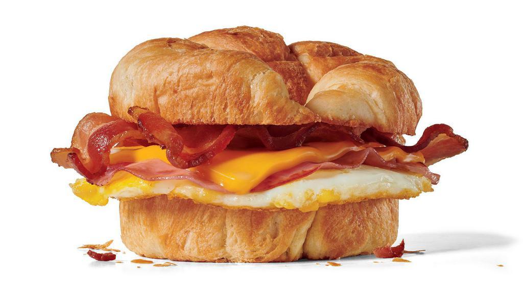 Supreme Croissant · We’ve come to be known for our wisecracks. Admittedly, we love to ham it up. Sometimes we even get a bit cheesy. In that spirit, this all-day breakfast sandwich features a freshly cracked egg, grilled ham, bacon, and cheese on a warm and flaky croissant.