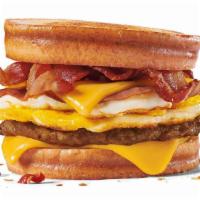 Loaded Breakfast Sandwich · Grilled Sourdough Bread loaded with 2 fried eggs, 2 slices of American cheese, bacon, ham an...