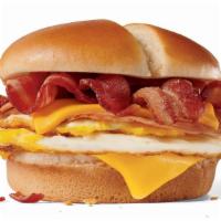 Ultimate Breakfast Sandwich · 2 fried eggs, 2 slices of ham, 2 slices of American cheese and 4 half-strips of bacon on a b...