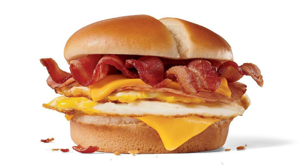 Ultimate Breakfast Sandwich · 2 fried eggs, 2 slices of ham, 2 slices of American cheese and 4 half-strips of bacon on a buttery bakery bun