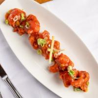 Gobi Manchurian · Deep fried cauliflower tossed with garlic, ginger, green onion, and tangy tomato sauce.